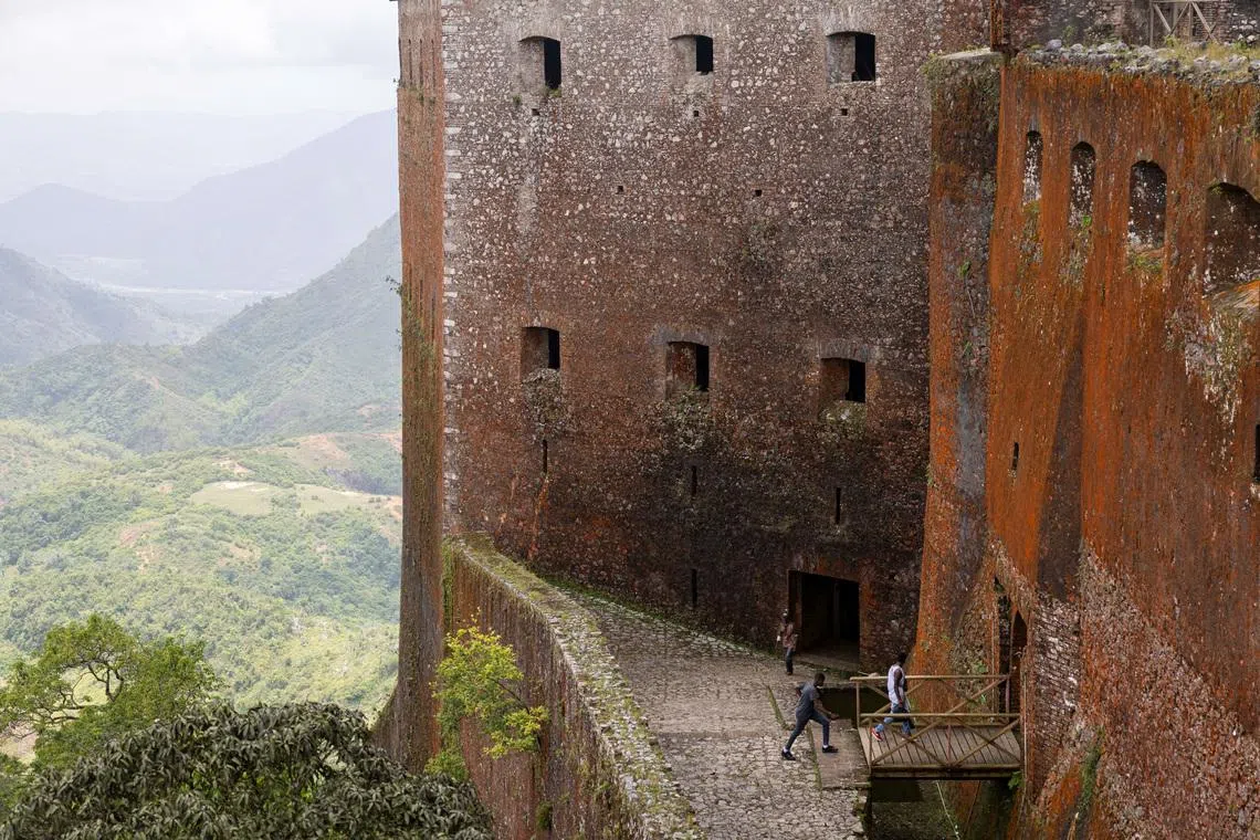 FILE PHOTO: People visit the Citadelle Laferriere, a fortress from the early 1800s commonly known as La Citadel in Milot, Haiti April 26, 2024. REUTERS/Ricardo Arduengo/File Photo