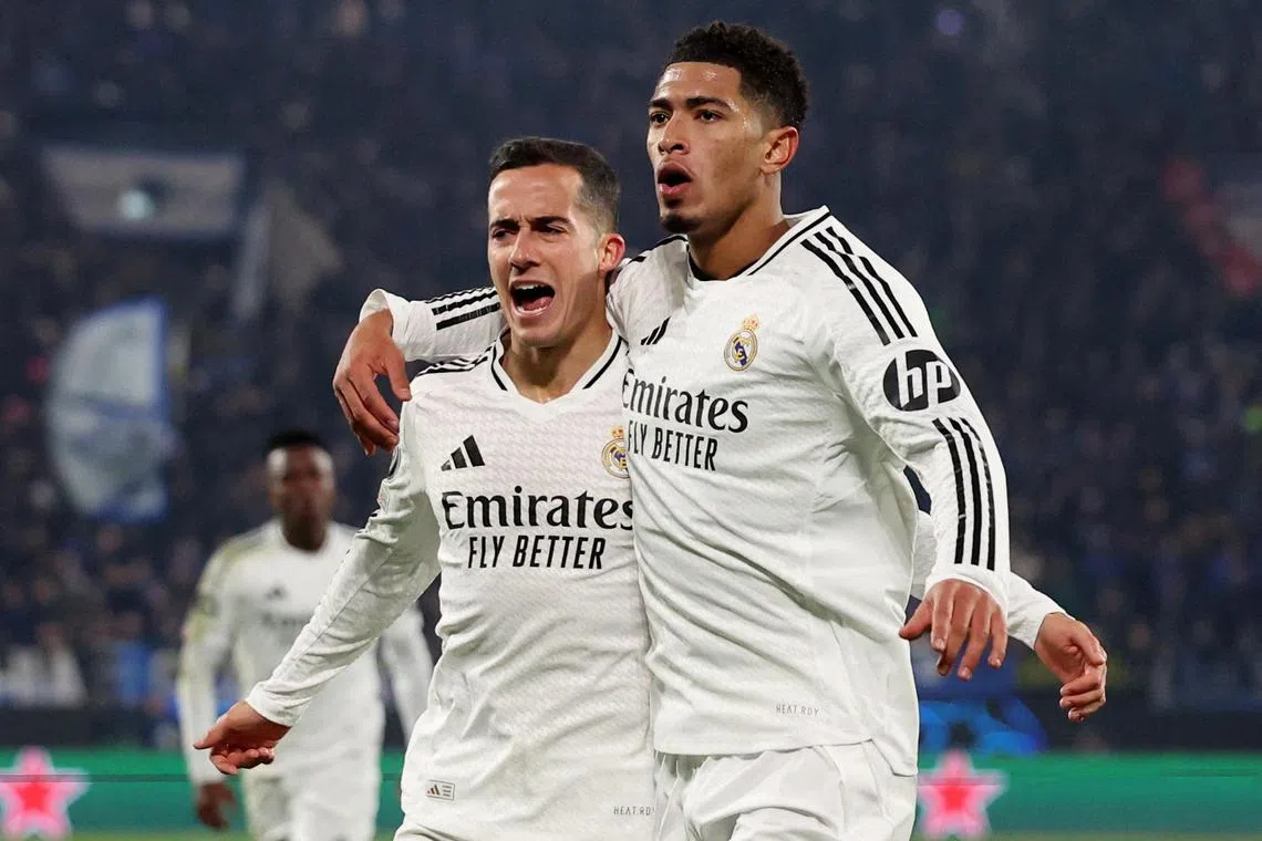 Real Madrid's Jude Bellingham (right) celebrates scoring their third goal with Lucas Vazquez.