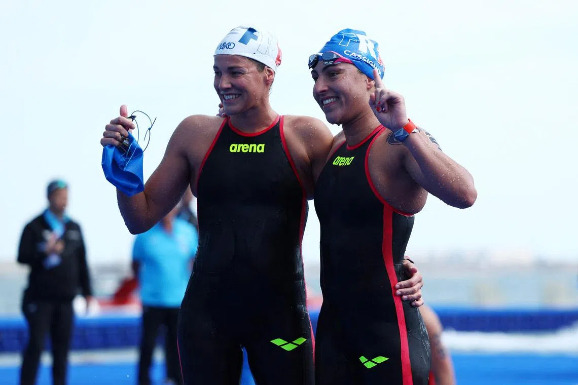 French swimmer Caroline Jouisse (right) celebrating with compatriot Oceane Cassignol after the women's 10km final at the World Aquatics Championships in Qatar in February 2024.