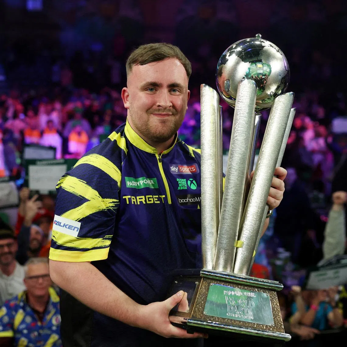 FILE PHOTO: Darts - World Darts Championship - Alexandra Palace, London, Britain - January 3, 2026 Luke Littler poses with the trophy after winning the World Darts Championship Action Images via Reuters/Paul Childs/File Photo