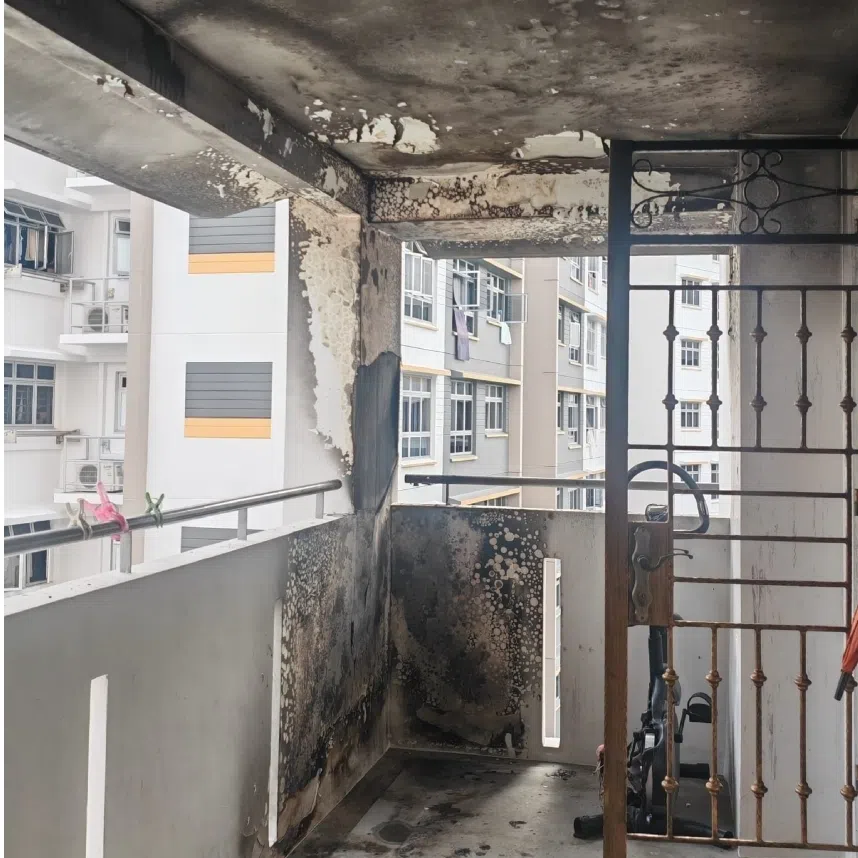 The exterior of a Woodlands Housing Board flat after a fire damaged the corridor’s ceiling and walls.