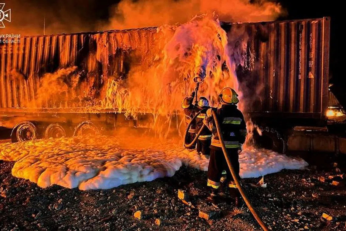 Firefighters work at a compound of a port on Danube river damaged by a Russian drone strike, amid Russia&#039;s attack on Ukraine, in Odesa region, Ukraine October 6, 2023. Press service of the State Emergency Service of Ukraine in Odesa region/Handout via REUTERS/File Photo