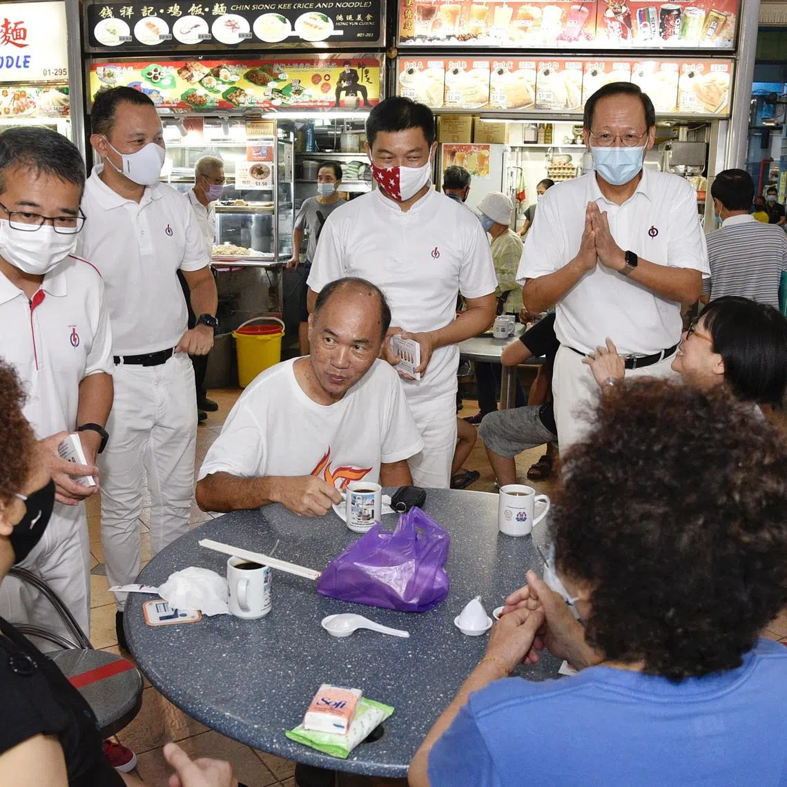 Mr Tan Chuan-Jin (standing, second right) with (from left) PAP Marine Parade GRC candidates Edwin Tong, Mohd Fahmi Aliman and Tan See Leng on a walkabout in July 2020. 