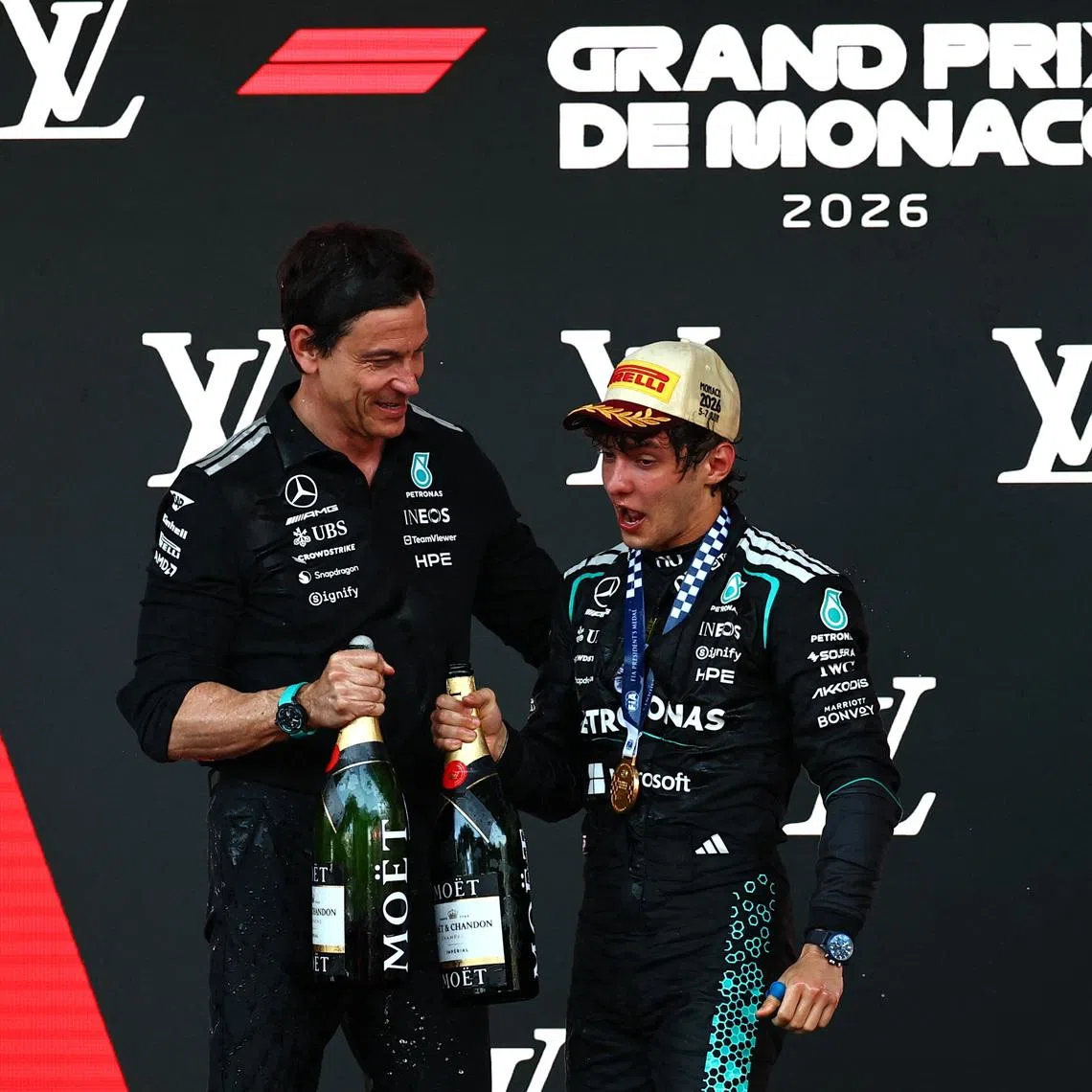 Formula One F1 - Monaco Grand Prix - Circuit de Monaco, Monaco - June 7, 2026 Mercedes' Andrea Kimi Antonelli celebrates on the podium with Mercedes team principal Toto Wolff after winning the Monaco Grand Prix REUTERS/Manon Cruz