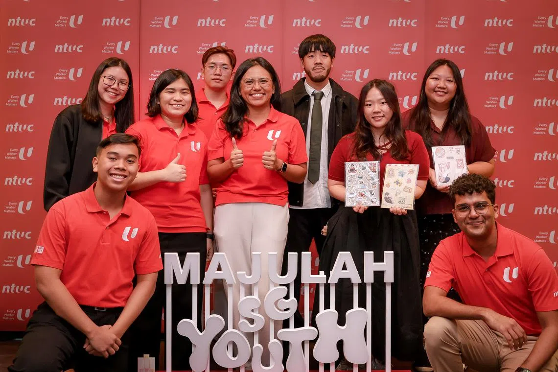 Ms Natasha Choy (centre, left), co-chairperson of the NTUC NDP Bay Celebrations organising committee, with local rapper Shigga Shay (centre, right) and youth volunteers.