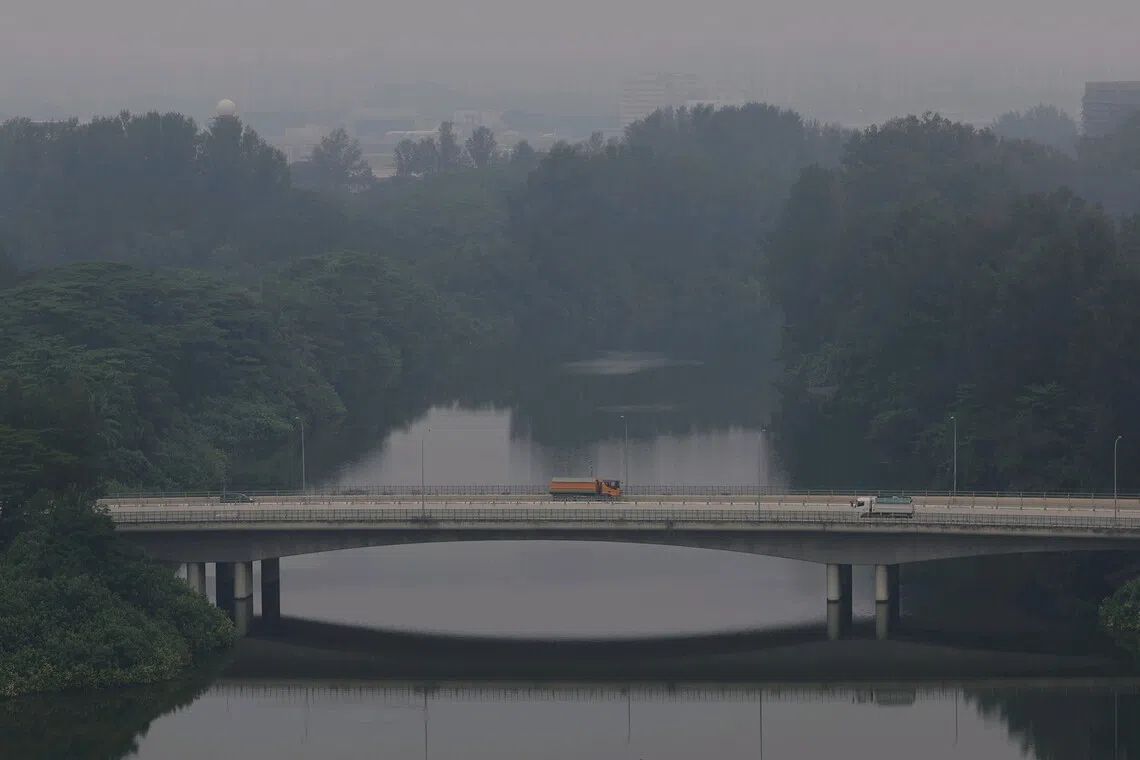 Vehicles travelling along Seletar Link during hazy conditions on Oct 20. NEA has issued legal notices to 10 companies in Indonesia under Singapore’s Transboundary Haze Pollution Act.