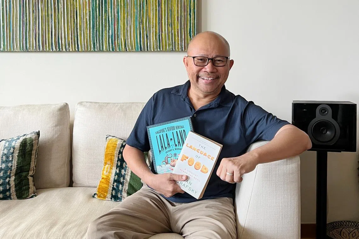 Award-winning author Khir Johari with some of the books he is currently reading.
