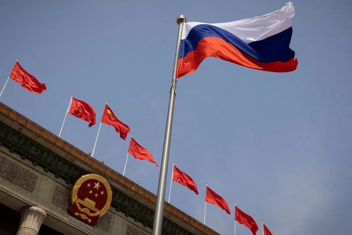 FILE PHOTO: The Russian national flag flies in front of the Great Hall of the People before a welcoming ceremony for Russian Prime Minister Mikhail Mishustin in Beijing, China, May 24, 2023. REUTERS/Thomas Peter/Pool/File Photo
