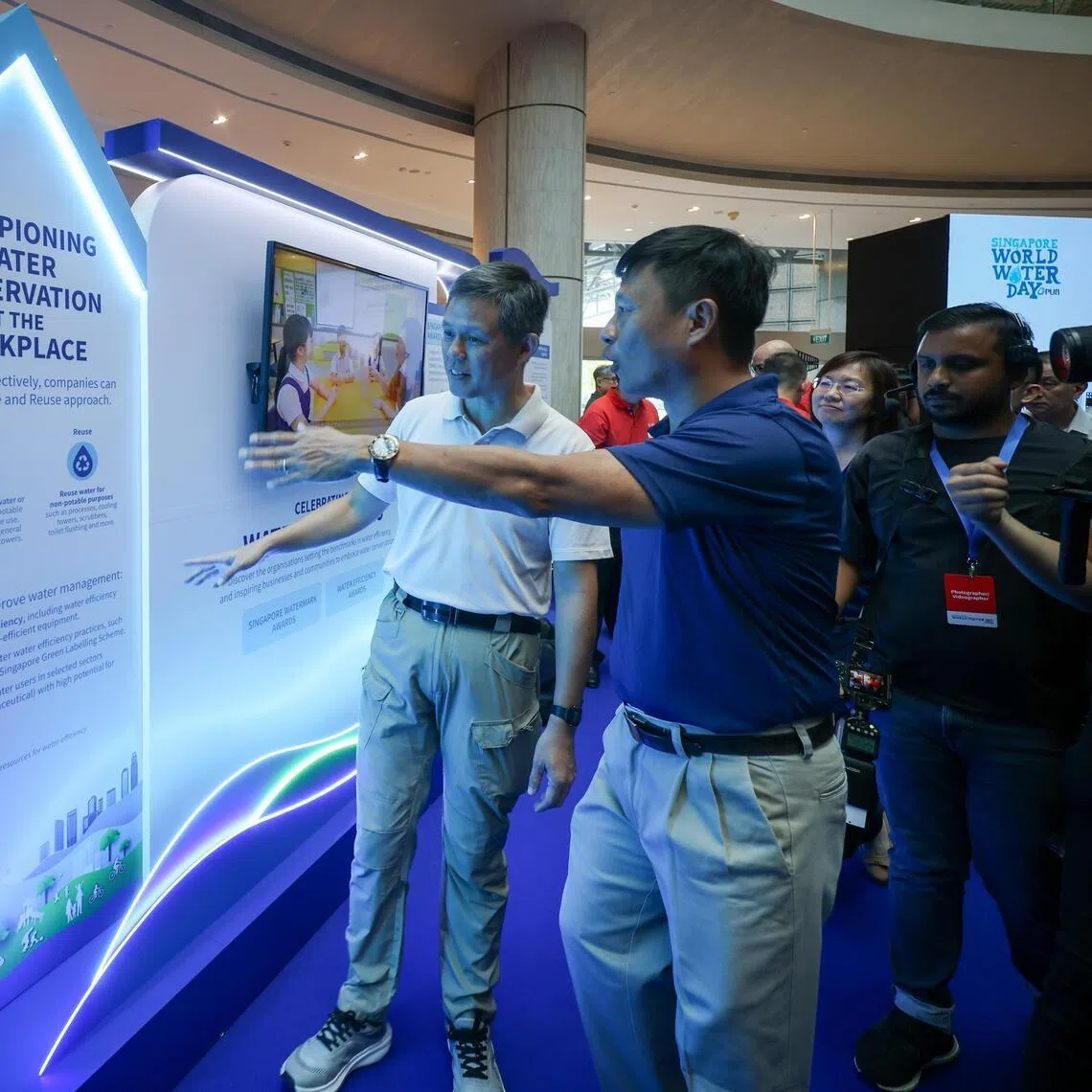 Coordinating Minister for Public Services Chan Chun Sing (left) and PUB chief executive Mr Ong Tze-Ch’in touring booths at Singapore World Water Day 2026 on March 17.
