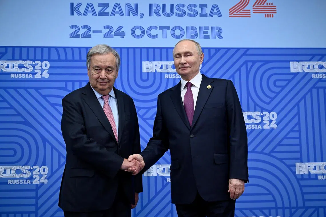 UN Secretary-General Antonio Guterres (left) shaking hands with Russian President Vladimir Putin at the Brics summit in Kazan, Russia, on Oct 24.