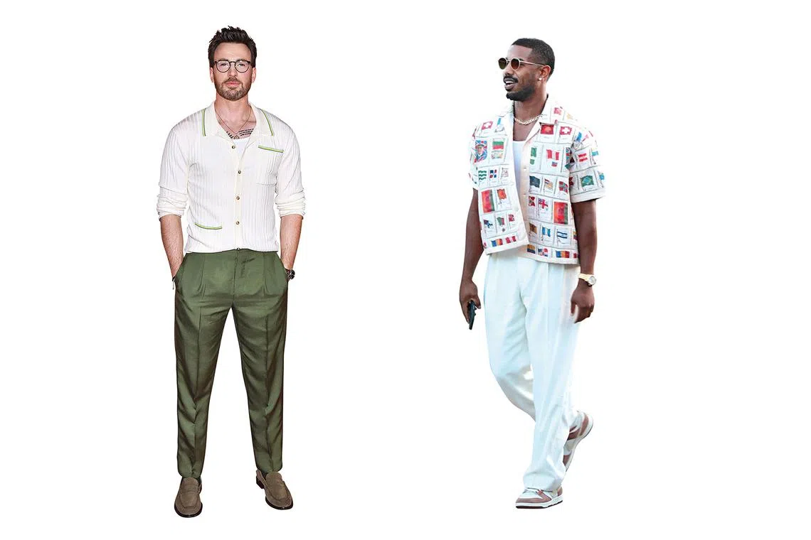 American actor Chris Evans in a cream knit that subtly clings to his body and American actor Michael B. Jordan in a tank top worn under a camp-collar shirt.