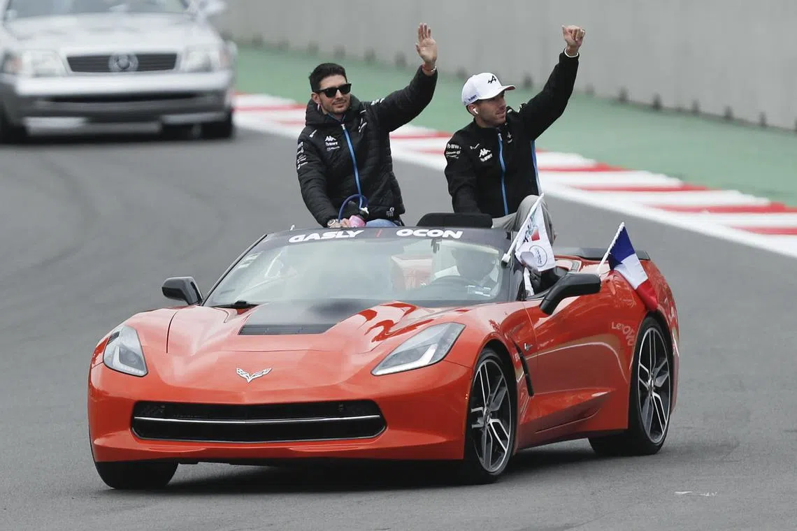 Alpine drivers Pierre Gasly (right) and Esteban Ocon wave during the drivers' parade ahead of the Mexican Grand Prix.