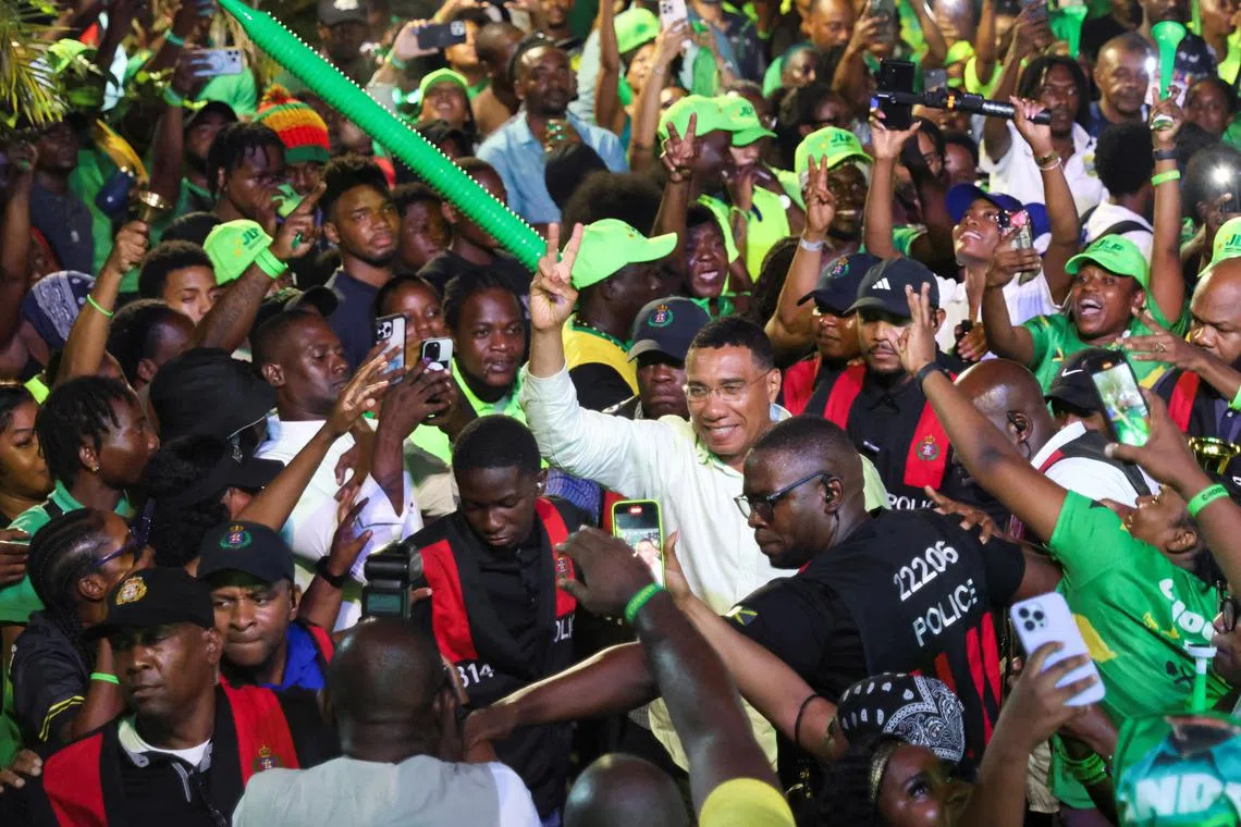 Jamaica's Prime Minister Andrew Holness walks amidst supporters after the ruling Labour Party declared victory in the general election, ushering in a third consecutive term for Holness, in Kingston, Jamaica September 4, 2025. REUTERS/Gilbert Bellamy