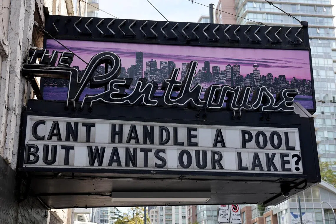 A sign reading “Can’t handle a pool but wants our lake?” is displayed outside The Penthouse nightclub in Vancouver.