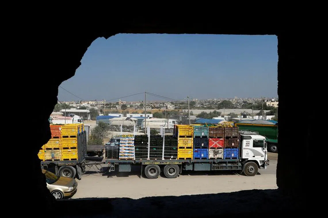 FILE PHOTO: A view of Palestinian goods trucks in front of the commercial crossing of Kerem Shalom after the Israeli ban on Gaza exports deals a blow to the long-suffering economy, in Rafah in the southern Gaza Strip September 5, 2023. REUTERS/Ibraheem Abu Mustafa/File photo