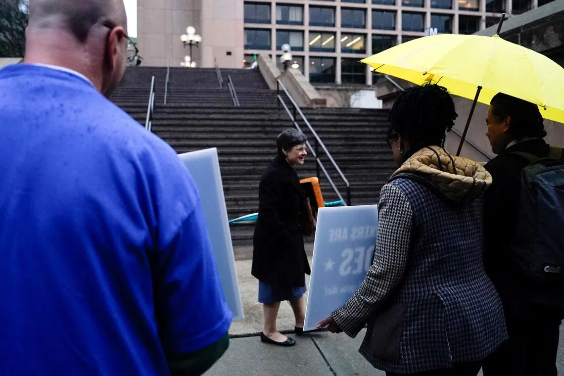 FILE PHOTO: Labor union members hold placards on the day of a rally in support of federal workers during a rush hour protest outside the L'Enfant Plaza Metro Station in Washington, D.C., U.S., March 24, 2025. REUTERS/Kent Nishimura/File Photo