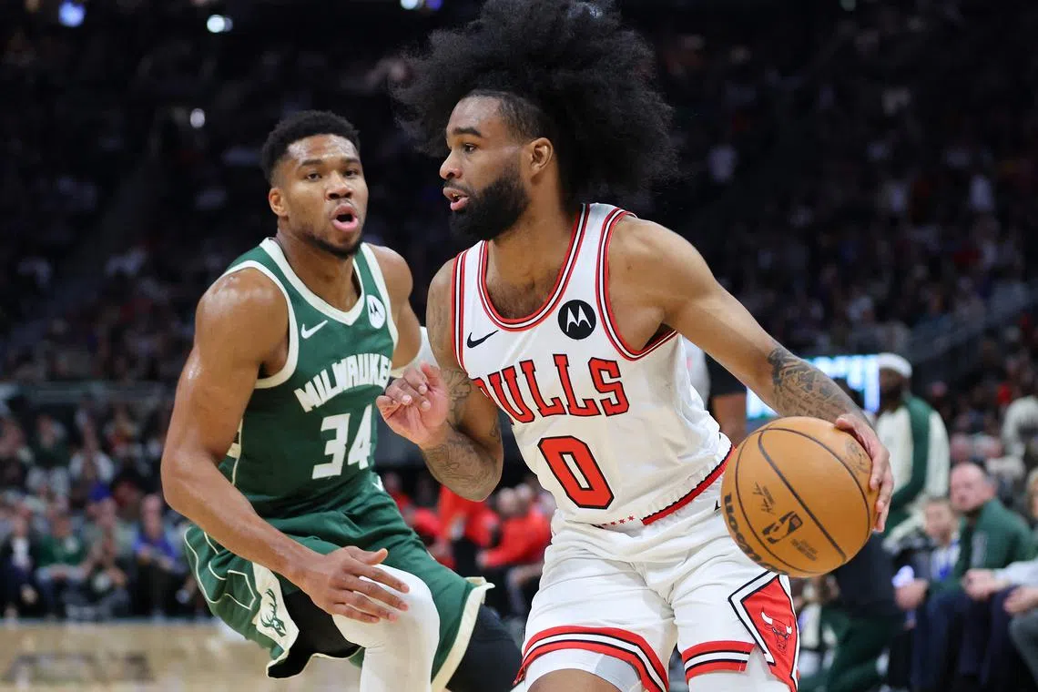 Coby White of the Chicago Bulls drives around Giannis Antetokounmpo of the Milwaukee Bucks during the first half at Fiserv Forum.