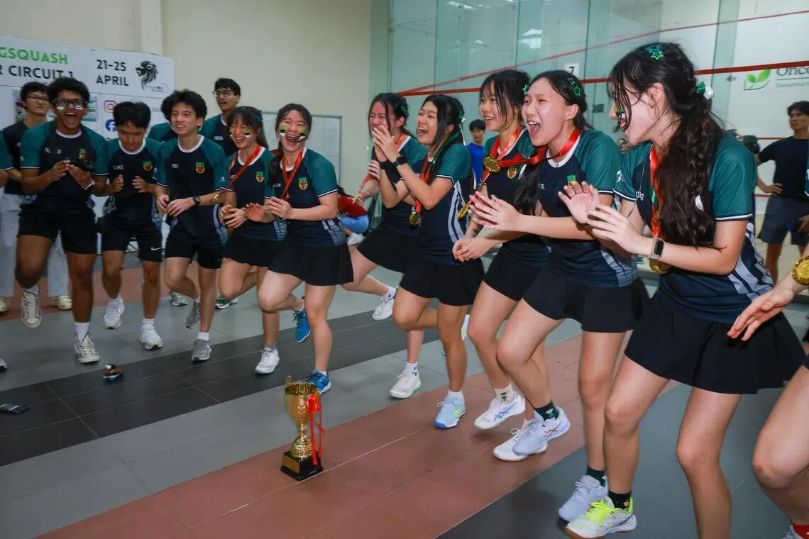  Raffles Institution cheering with teammates and supporters after RI won the Girls A Division Squash final at Kallang Squash Centre on May 6, 2026. 
