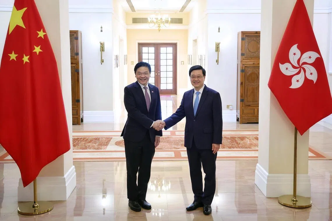 Prime Minister Lawrence Wong shaking hands with Hong Kong Chief Executive John Lee during a meeting and lunch hosted at the Government House in Hong Kong on March 27, 2026. ST PHOTO: KEVIN LIM mfpmhk27
