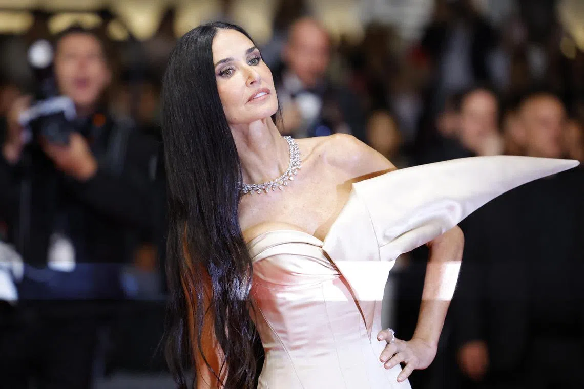 Cast member Demi Moore poses on the red carpet during arrivals for the screening of the film The Substance in competition at the 77th Cannes Film Festival in Cannes, France, on May 19, 2024. 