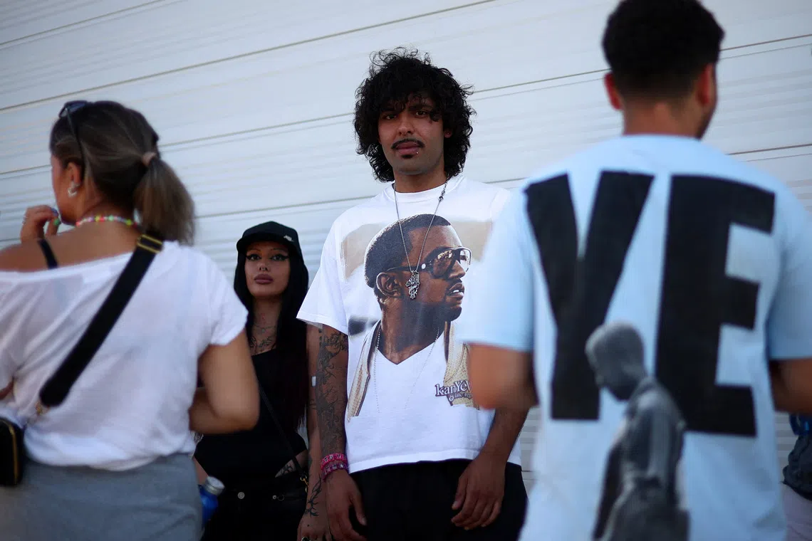 A man wearing a shirt bearing the image of US rapper Kanye West, also known as Ye, ahead of the Kanye concert in Tirana, Albania, on July 11.