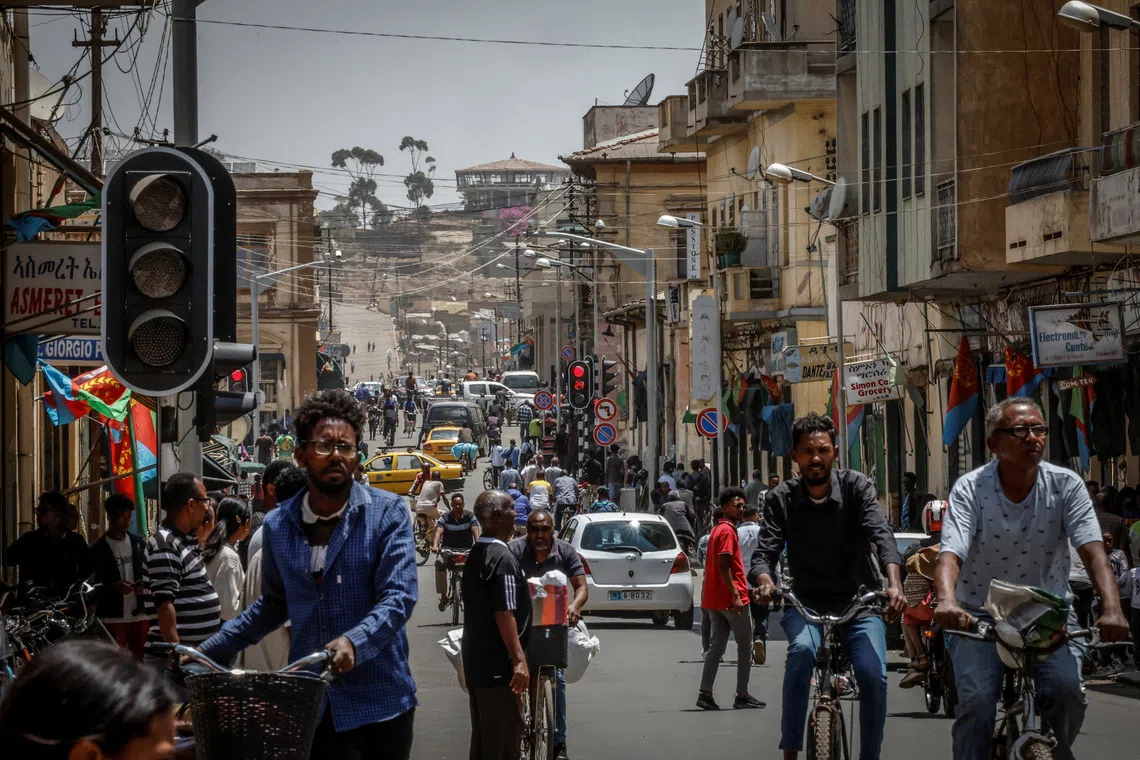 People walk and ride bicycles on a busy street in downtown Asmara, Eritrea, June 19, 2026. Eritrea has long been isolated by the West, which views the East African country as among the most repressive in the world, while the government in Asmara has itself pursued a policy of political and economic seclusion. Despite its small population, Eritrea has gained new geopolitical importance this year, during the Iran war, because of its 1,000-km Red Sea coastline along a key shipping route between the Mediterranean and Asia. As conflict disrupted traffic through the Strait of Hormuz and attacks by Iran-backed Houthi militants threatened vessels near Yemen, Eritrean waters emerged as potentially one of the safest corridors for maritime trade. REUTERS/Monicah Mwangi