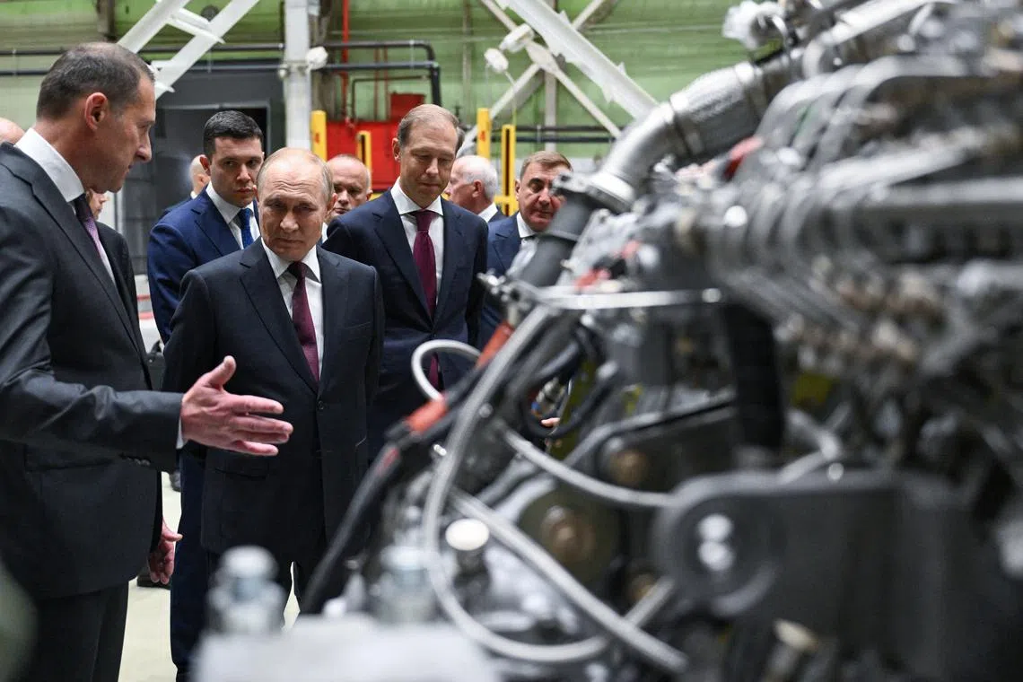 Russian President Vladimir Putin touring the Kuznetsov design bureau aircraft engine manufacturing plant in the southern city of Samara on Sept 5.