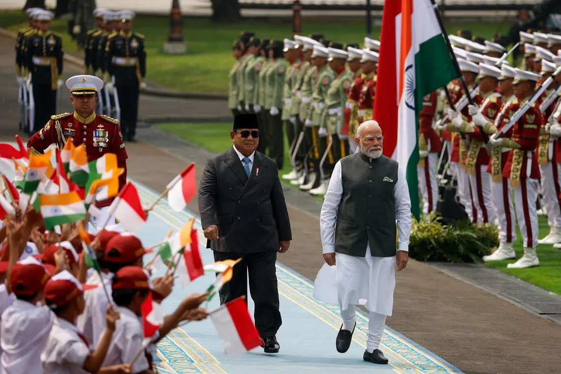 Indian PM Narendra Modi (right) and Indonesia’s President Prabowo Subianto during the welcoming ceremony prior to ther meeting at Merdeka Palace in Jakarta, on July 7.
