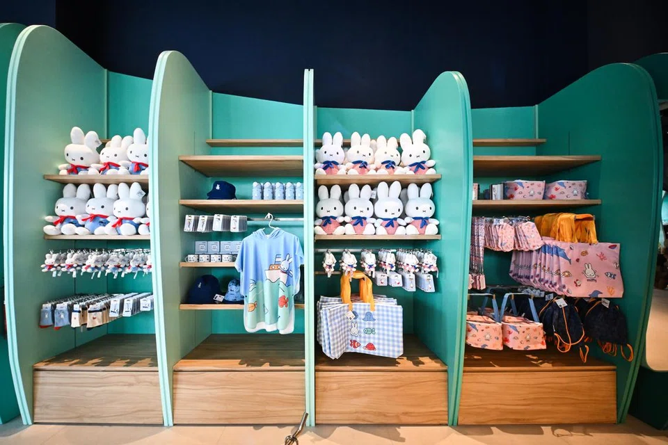A gift shop display featuring Miffy merchandise and plush toys