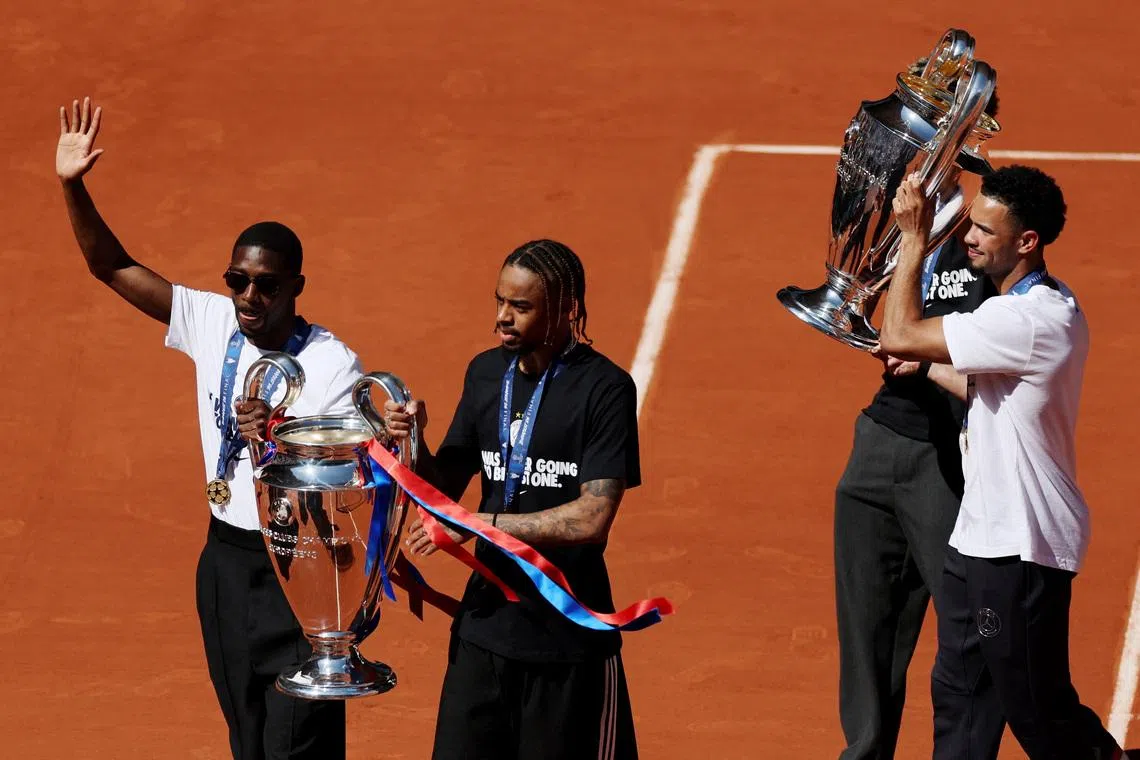 Tennis - French Open - Roland Garros, Paris, France - June 1, 2026 Paris St Germain's Ousmane Dembele, Bradley Barcola, Desire Doue and Warren Zaire-Emery as they present their back-to-back UEFA Champions League trophies to the spectators in the stands after winning the final against Arsenal REUTERS/Stephane Mahe