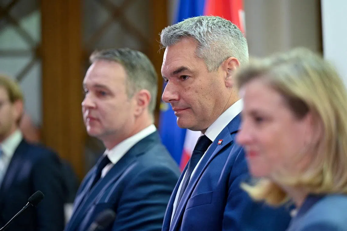 FILE PHOTO: Austrian Chancellor and head of the People's Party (OeVP) Karl Nehammer, head of the Social Democrats Andreas Babler and head of NEOS party Beate Meinl-Reisinger give a press statement to announce the start of coalition negotiations in Vienna, Austria, November 18, 2024. REUTERS/Elisabeth Mandl/File Photo
