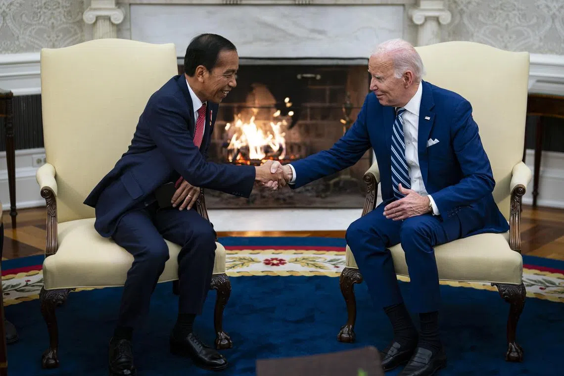US President Joe Biden (right) shakes hands with Indonesia's President Joko Widodo in the Oval Office on Monday. 