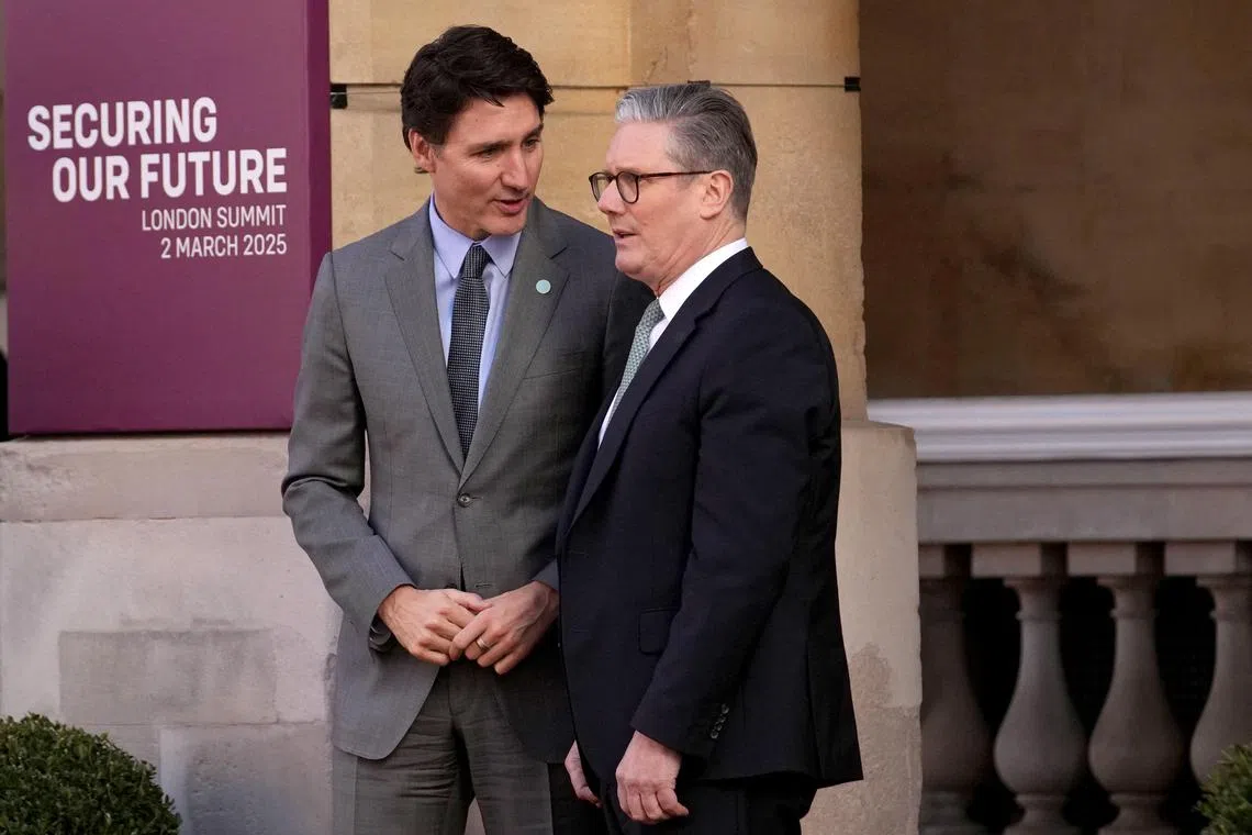 Britain's Prime Minister Keir Starmer (right) greeting Canada's Prime Minister Justin Trudeau as he arrives to attend a summit held at Lancaster House in London on March 2. 