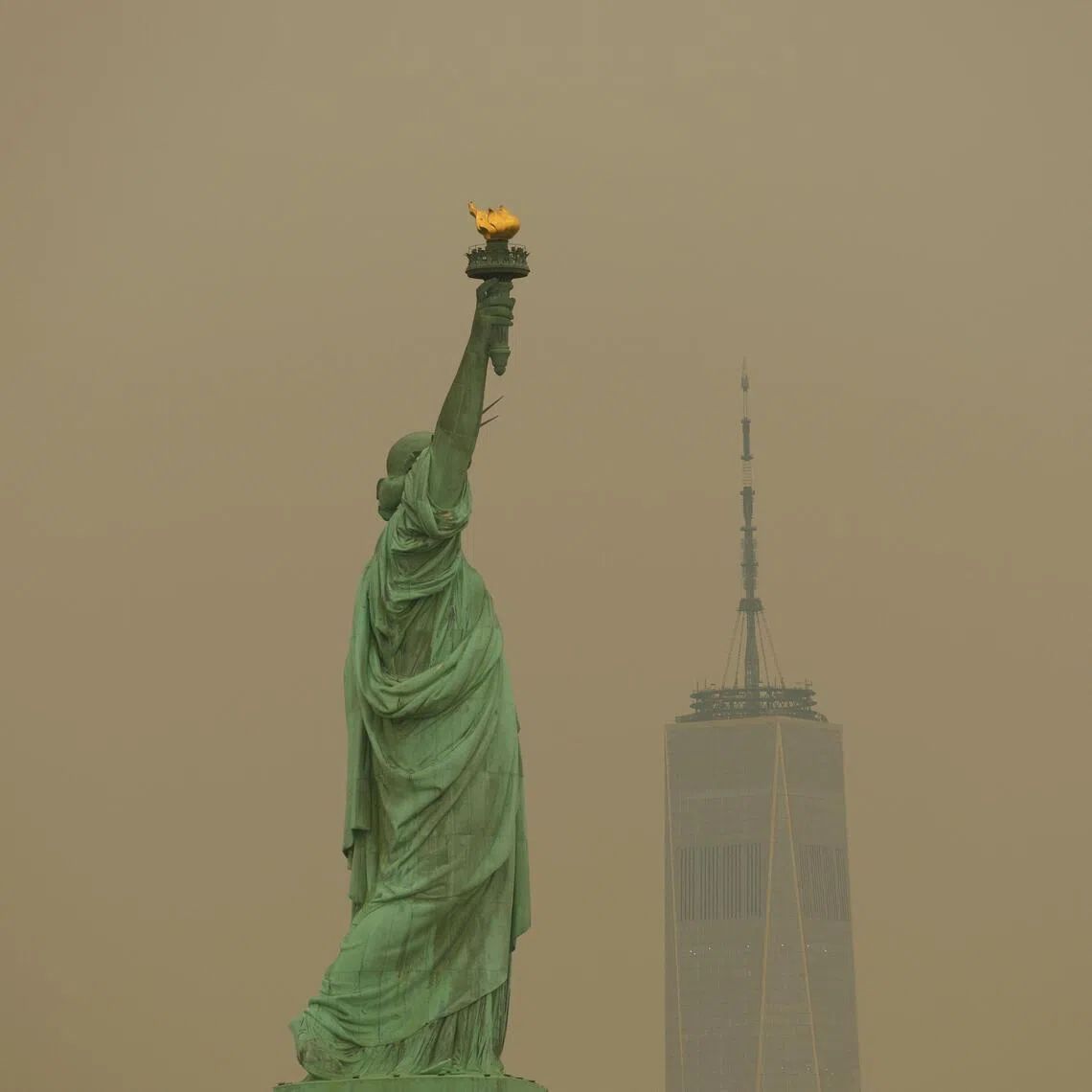 New York’s Statue of Liberty seen through the haze of wildfire smoke on July 16.
