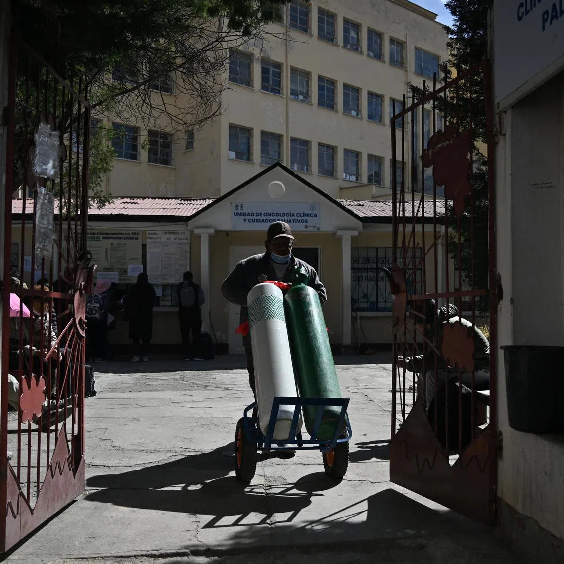 A worker at the General Hospital moves two oxygen tanks, amid prolonged road blockades that have disrupted the supply of food, fuel and medicine, causing a severe crisis in La Paz, Bolivia, June 18, 2026. REUTERS/Claudia Morales