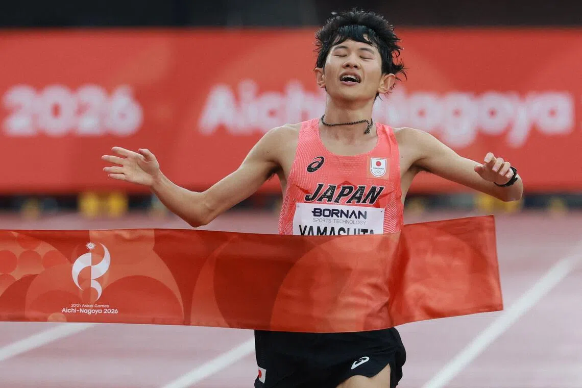 Ichitaka Yamashita crossing the finishing line to win gold in the men’s marathon final of the 2026 Asian Games at Nagoya City Mizuho Park Athletic Stadium in Nagoya, on Sept 26.