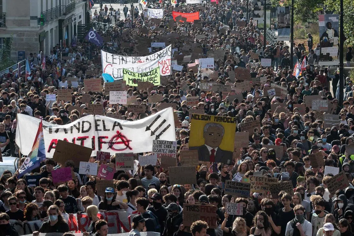 Protesters hold placards as part of a nationwide protest movement over learning conditions in France on Oct 6.