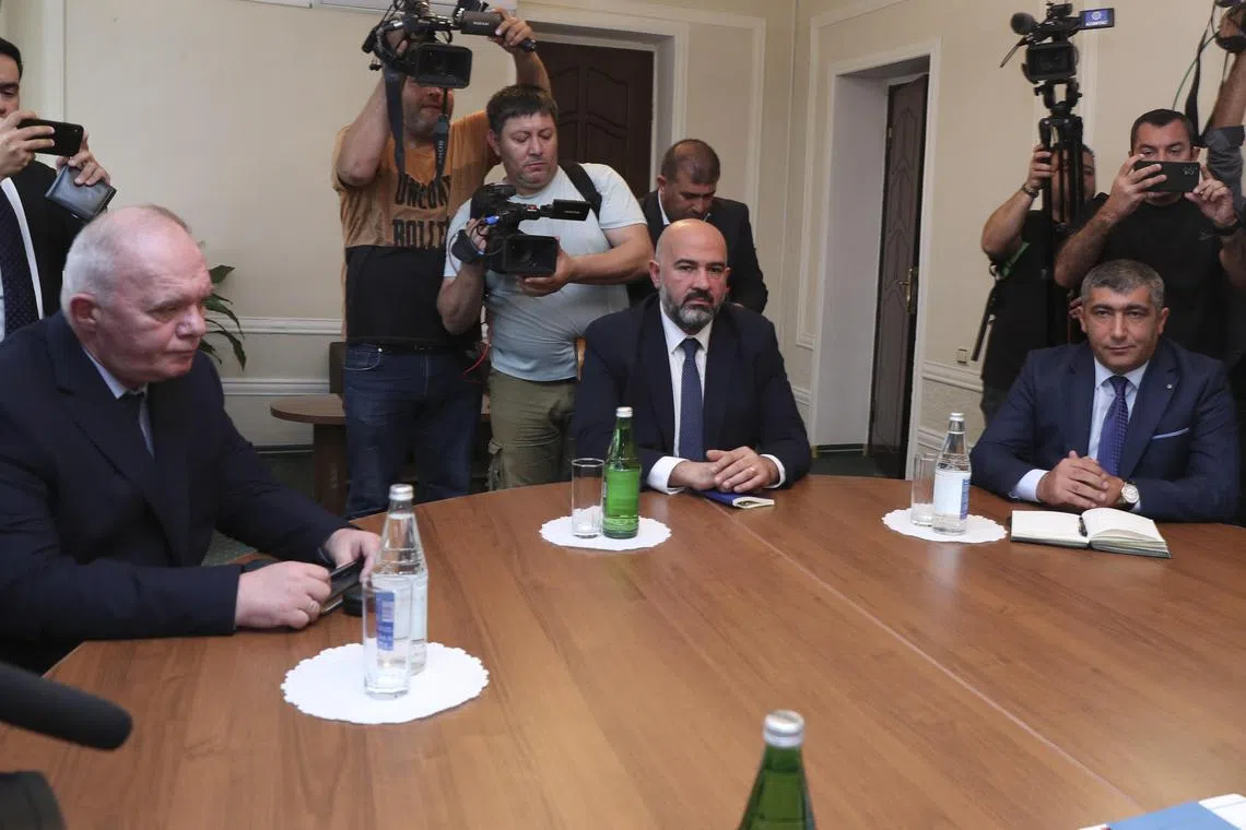 Mr Davit Melkumyan (centre) and Mr Areg Avagyan (right), deputies of the National Assembly of Nagorno-Karabakh, during talks with Azerbaijani officials in Yevlakh, Azerbaijan.