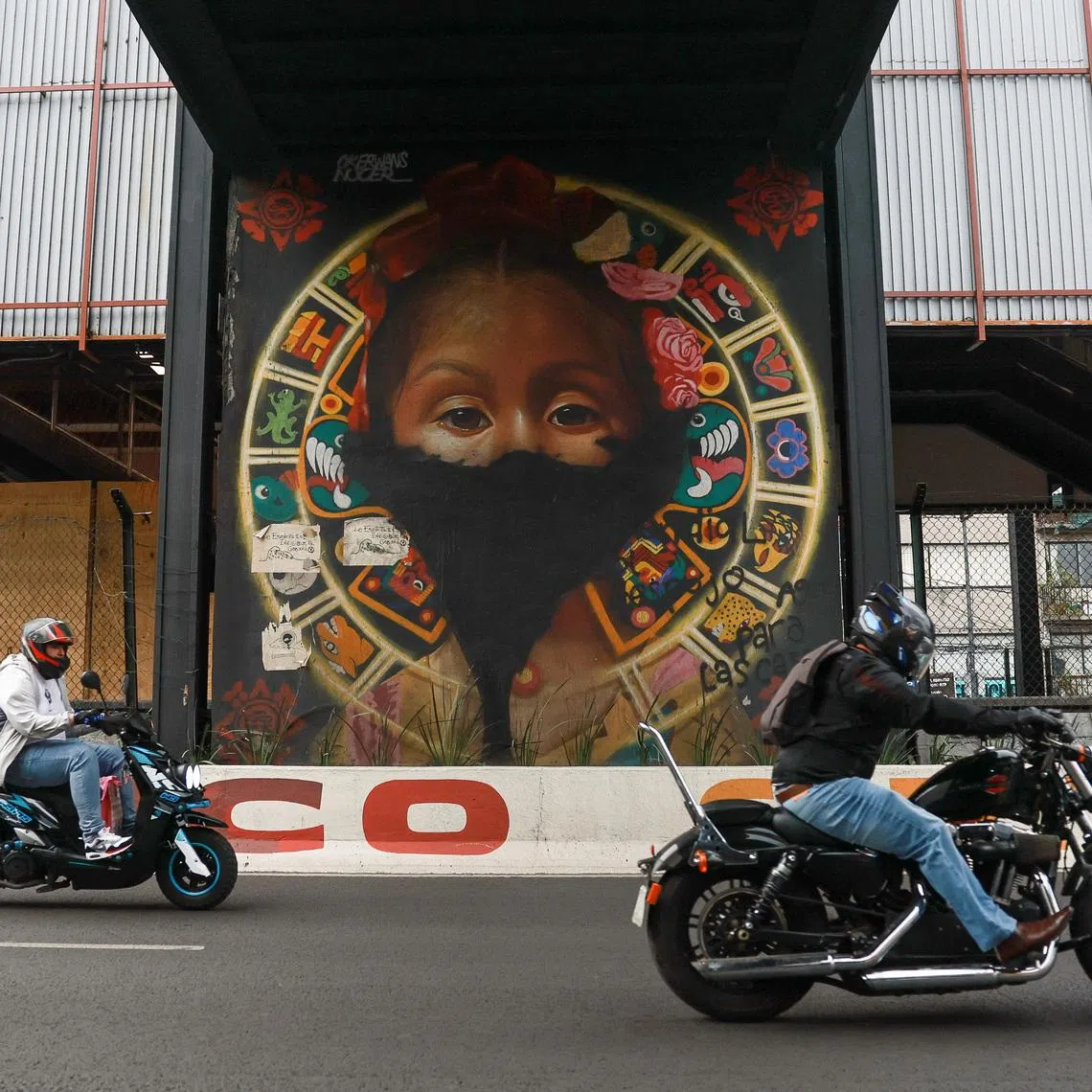 Motorcyclists ride past a subway station where renovation work is underway to upgrade entrances, platforms, and structural elements ahead of the World Cup's opening match on June 11, in Mexico City, Mexico, May 17, 2026. REUTERS/Henry Romero
