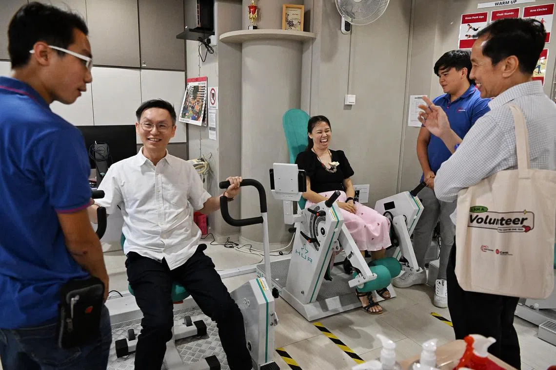 From left: Dr Kevin Loy, a family physician at Doctors Inc Medical Group, Dr Tan Lye Yoong, deputy head of Toa Payoh Polyclinic, and Dr Tham Kwong Lum, a family physician at Mediview Clinic and Surgery, were given a tour of the gym facilities at Care Corner Singapore's active ageing centre in Lorong 4 Toa Payoh by the social service agency's staff (in blue tops) on May 13, 2023.