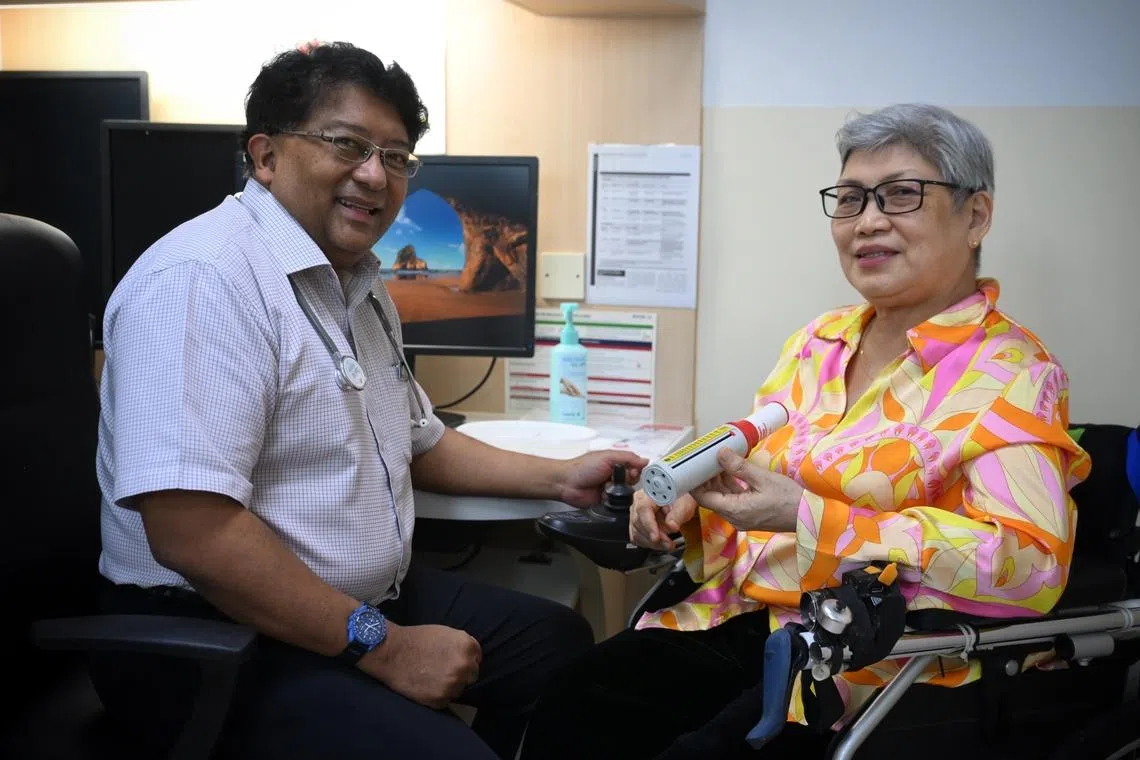 NHG Health’s chief of health services and outcomes research John Abisheganaden examining Madam Merly Hong, a patient with Tan Tock Seng Hospital since 2016.