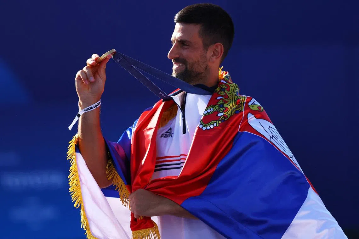 FILE PHOTO: Paris 2024 Olympics - Champions Park medallists celebrations - Champions Park, Paris, France - August 05, 2024. Tennis Men's Singles gold medallist Novak Djokovic of Serbia poses with his medal during the Champions Park medallists celebrations. REUTERS/Stephanie Lecocq/File Photo