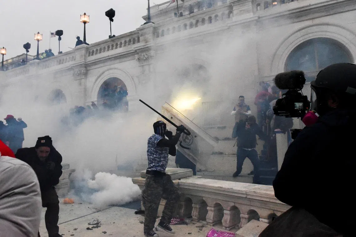 FILE PHOTO: Police clear the U.S. Capitol Building with tear gas as supporters of U.S. President Donald Trump gather outside, in Washington, U.S. January 6, 2021/File Photo