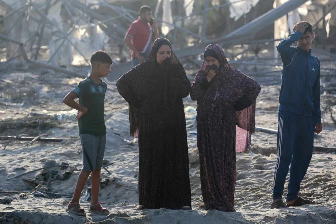Palestinians inspecting the damage from an Israeli strike on a makeshift displacement camp in the southern Gaza Strip, on Sept 10.