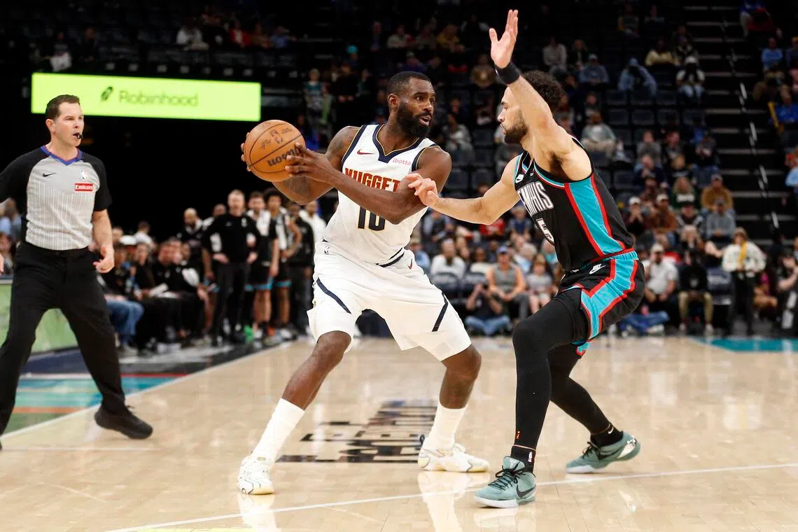 Denver Nuggets guard Tim Hardaway Jr. handles the ball as Memphis Grizzlies forward Tyler Burton defends during the fourth quarter at FedExForum.