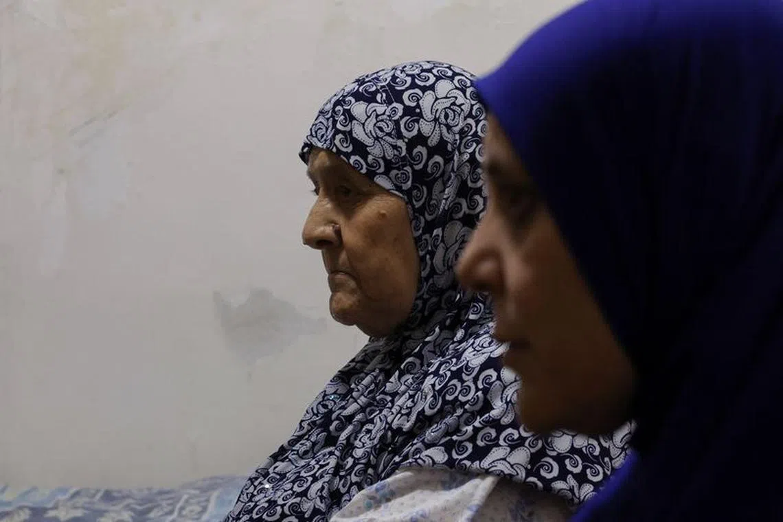 Khadjeh Chehadeh Abu Stateh, 84, left, a Palestinian refugee who fled the 1948 Arab-Israeli war, and her daughter, Zahra Ahmed Abu Stateh, 51, sit at their residence in Bourj al-Barajneh Refugee Camp in Beirut, Lebanon, October 25, 2023. REUTERS/Amr Alfiky