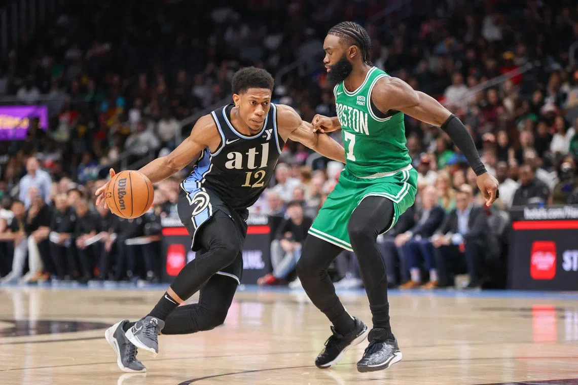 Atlanta Hawks forward De'Andre Hunter is defended by Boston Celtics guard Jaylen Brown in the second half at State Farm Arena.