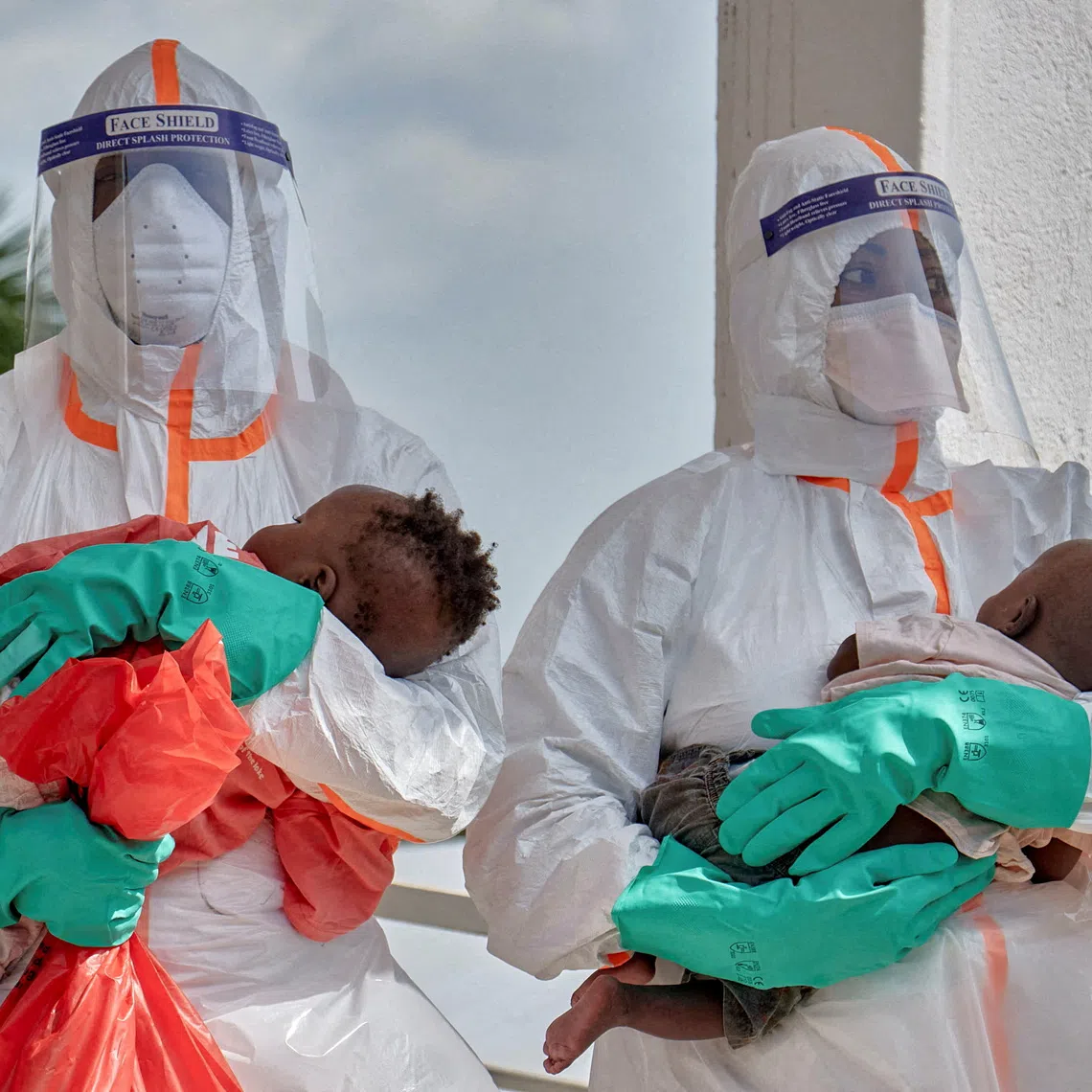 FILE PHOTO: Congolese medical workers dressed in personal protective equipment (PPE) carry children tested and cleared off from Ebola from Saint Nicholas orphanage, at the Centre Medical Evangelique (CME) within the secured Ebola response zone, as aid agencies intensify efforts to contain the Ebola outbreak involving the Bundibugyo strain, in Hoho commune of Bunia town, Ituri province, Democratic Republic of Congo, June 9, 2026. REUTERS/Gradel Muyisa Mumbere/File Photo