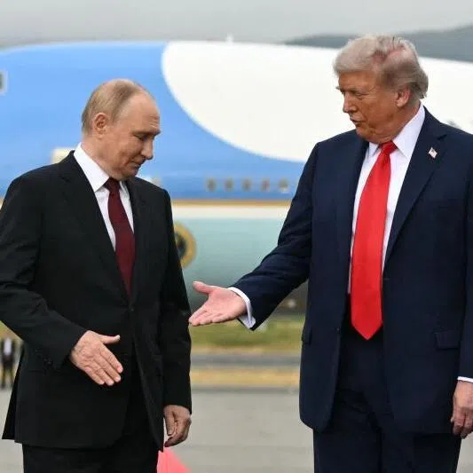 US President Donald Trump (right) reaches out to shake hands with Russian President Vladimir Putin after his arrival at Joint Base Elmendorf-Richardson in Anchorage, Alaska on Aug 15.