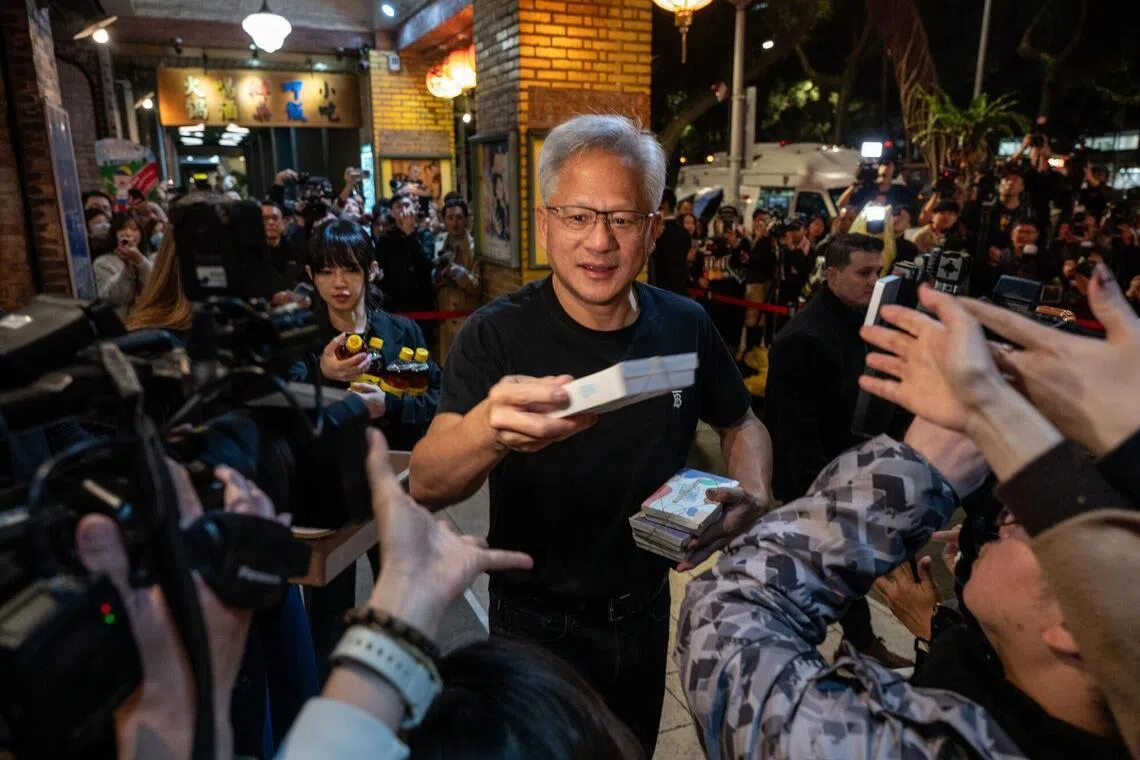 Nvidia Corp chief executive officer Jensen Huang hands out food to supporters on Jan 31, 2026, during a dinner event with the company's Taiwanese suppliers in Taipei, Taiwan.